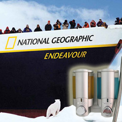 People standing on bow of boat looking at polar bear national geographic endeavour dispensers in foreground dispenser amenities