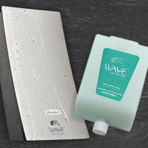 Wave body lotion cartridge beside wave dispenser covered in water droplets dispenser amenities