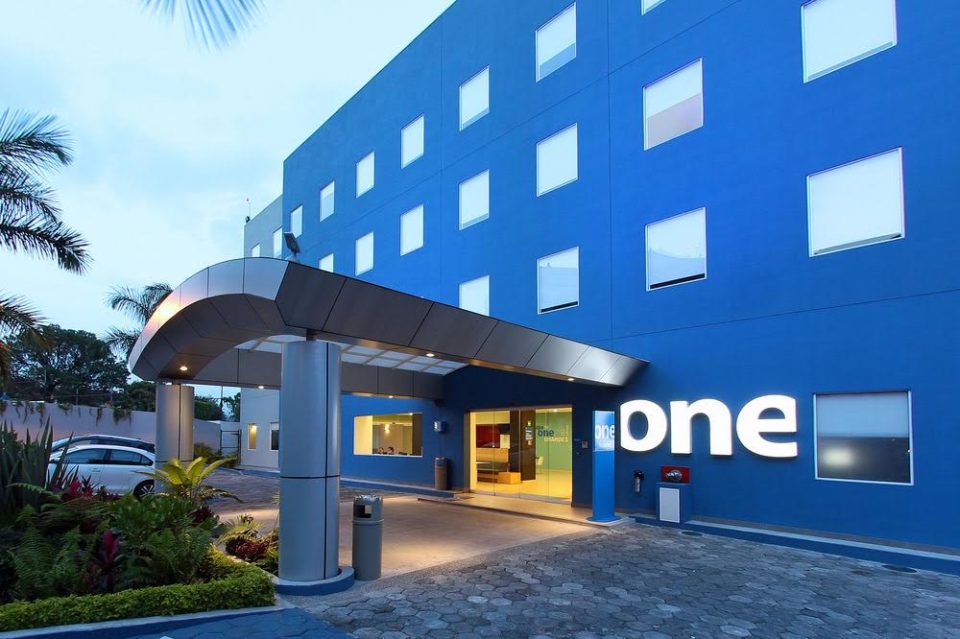 one hotel blue building front entrance dispenser amenities