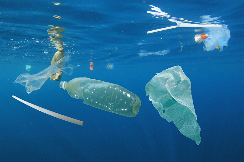 Plastic ocean pollution. Underwater bags, bottles, cups, straws